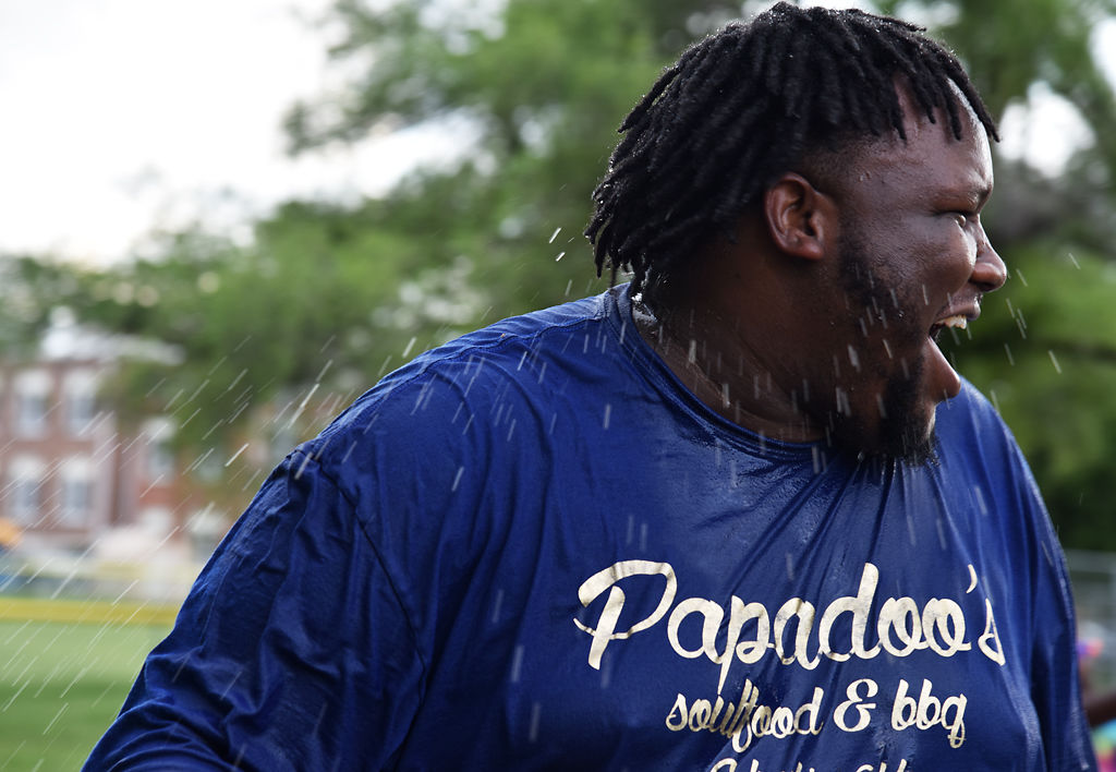 Joshua Williams laughs after being doused in water during the Juneteenth Water Fight